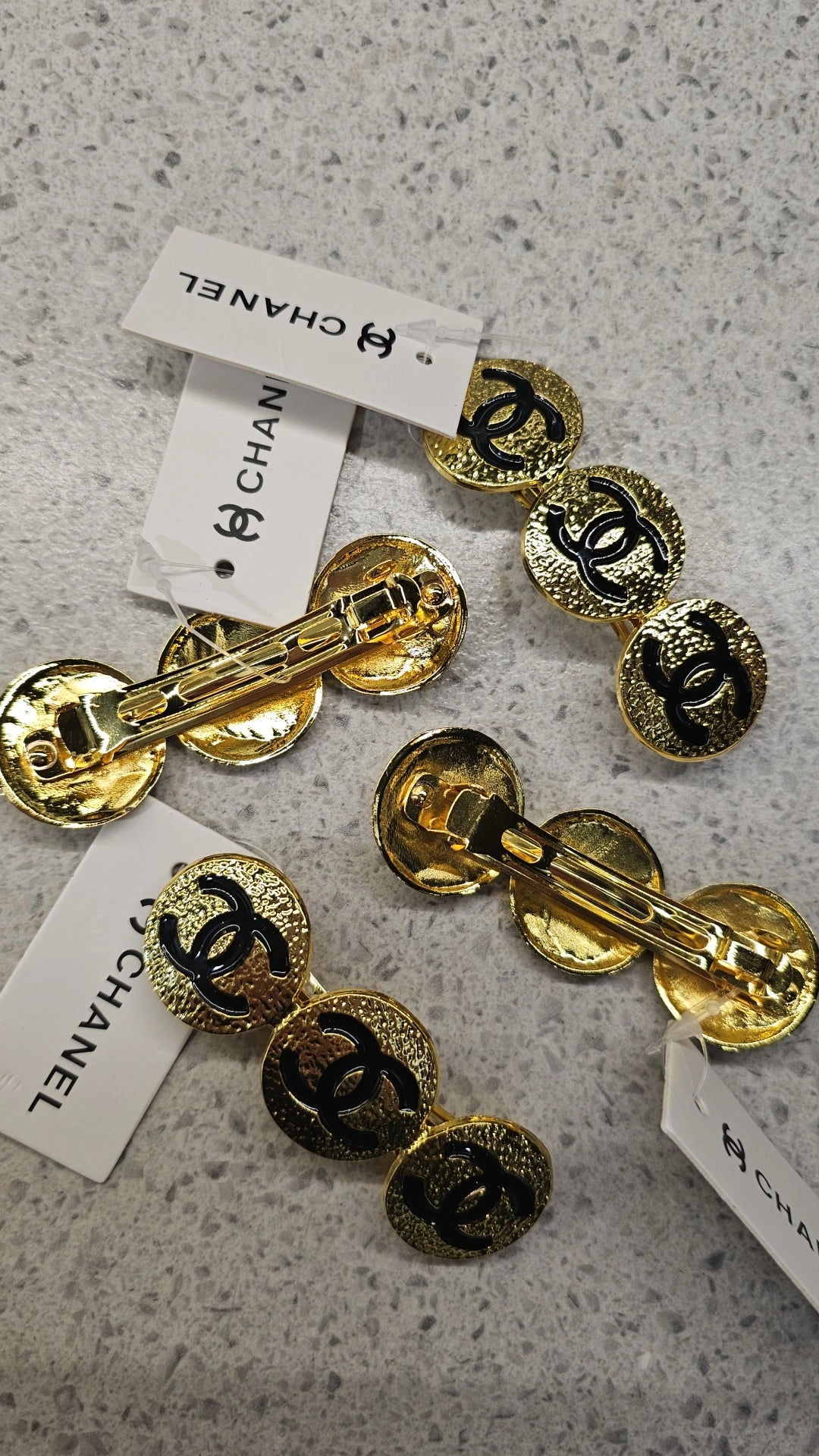 Gold hair barrette with black C circles
